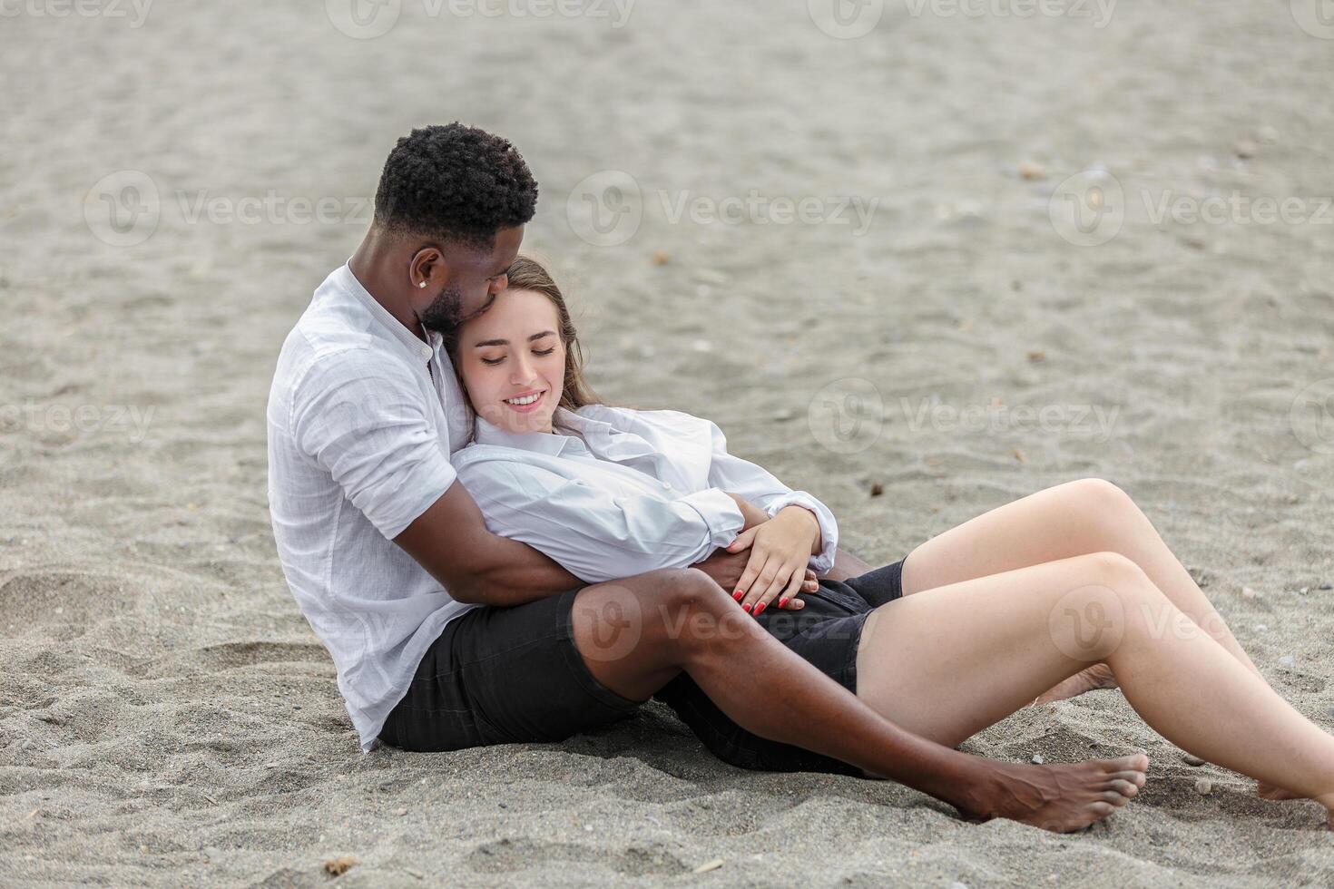 Couple enjoying a relaxing moment together on Zapillo Beach in Almeria, Spain during a sunny day by the sea photo