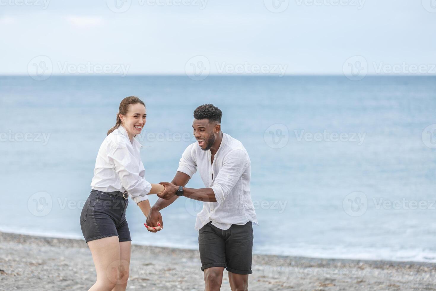 Joyful moments at Playa del Zapillo in Almeria, Spain, as a couple enjoys playful interaction by the serene beach photo