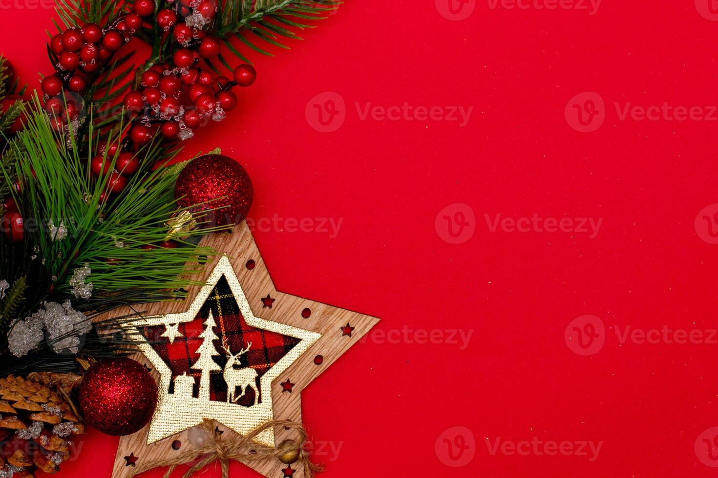 Top view photo christmas spruce branch,christmas star decor on red background for greeting card. Xmas backdrop with space for text.Copyspace.