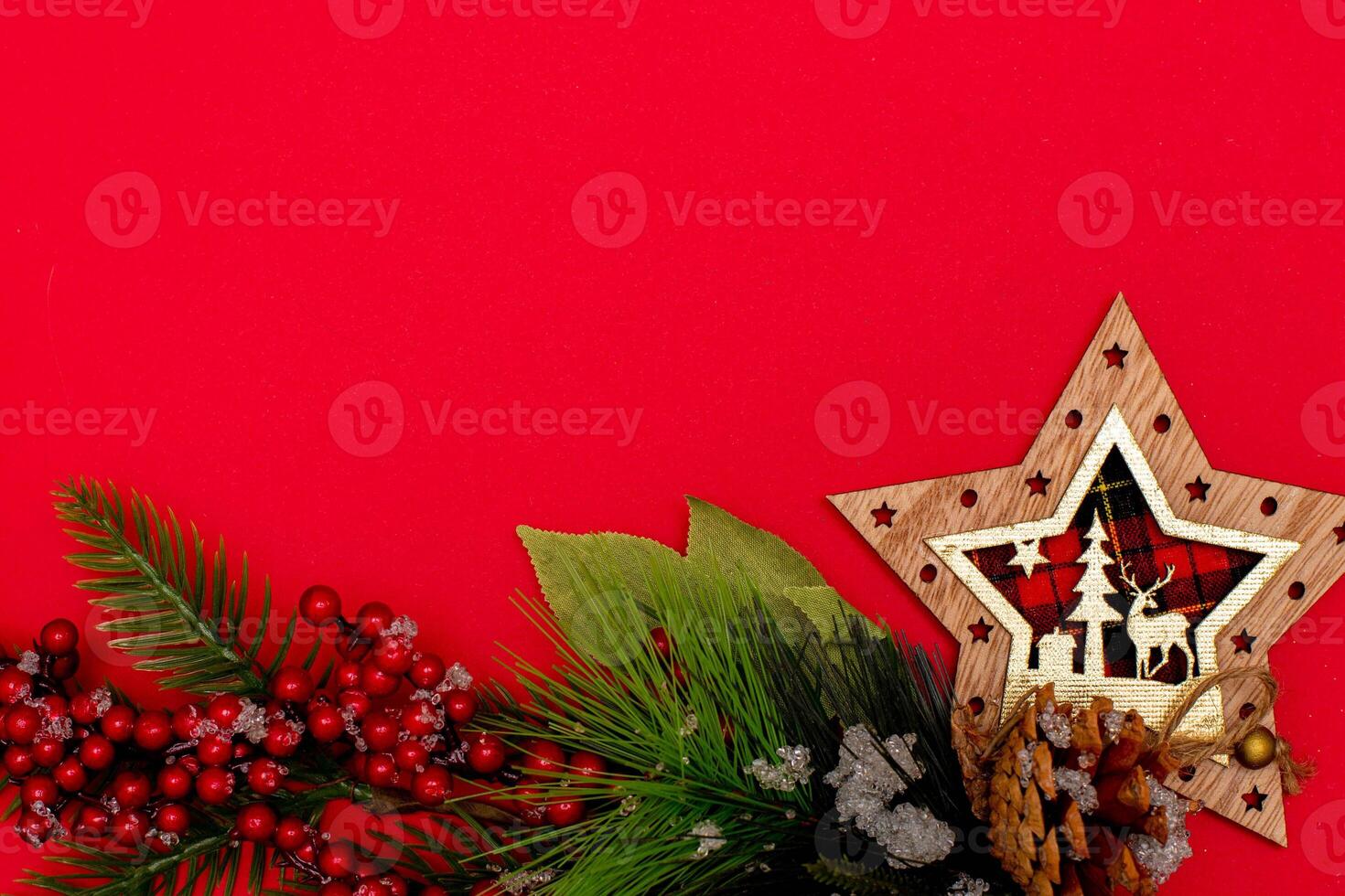 Top view photo christmas spruce branch,christmas star decor on red background for greeting card. Xmas backdrop with space for text.Copyspace.