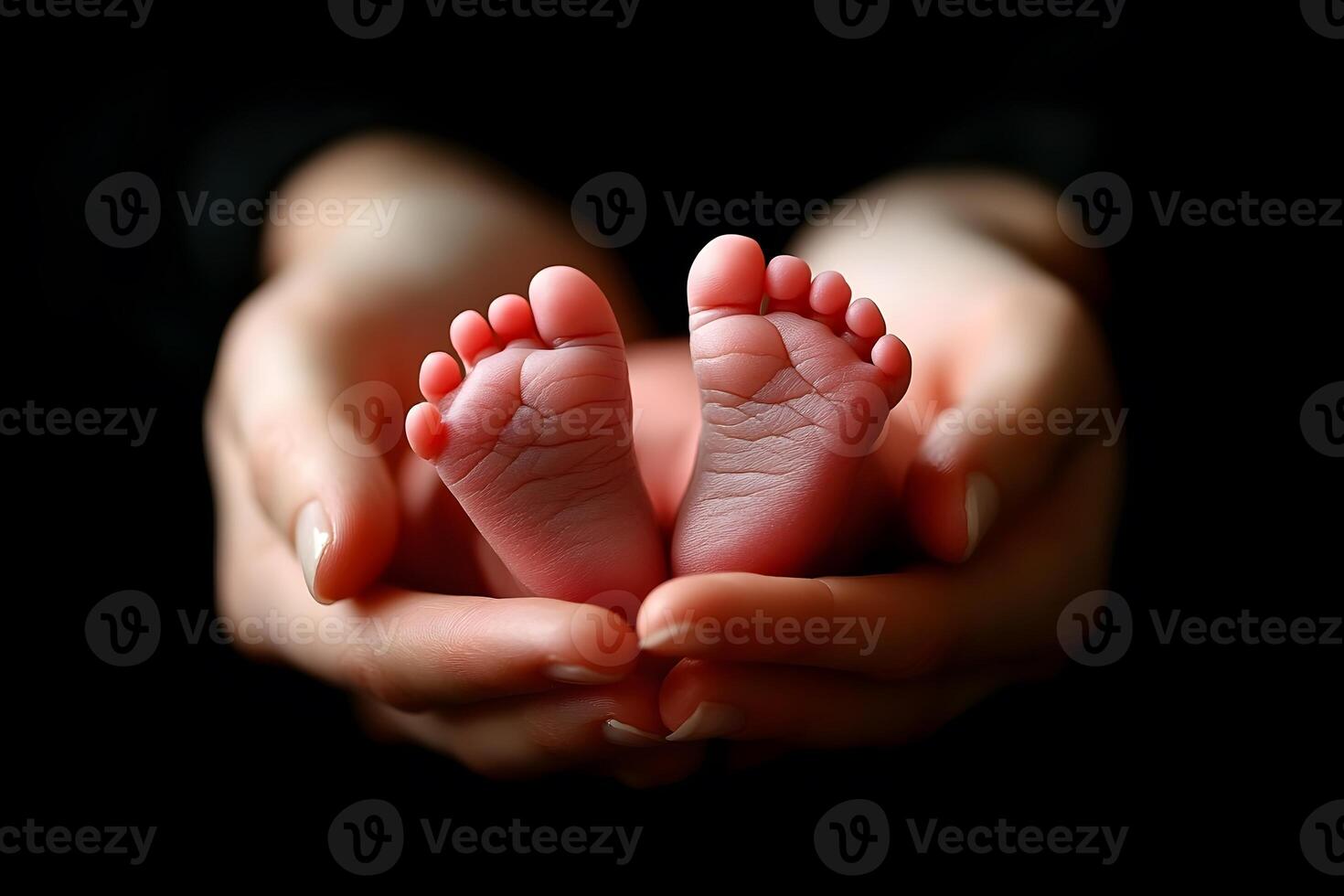 A person holding a baby's feet in their hands photo