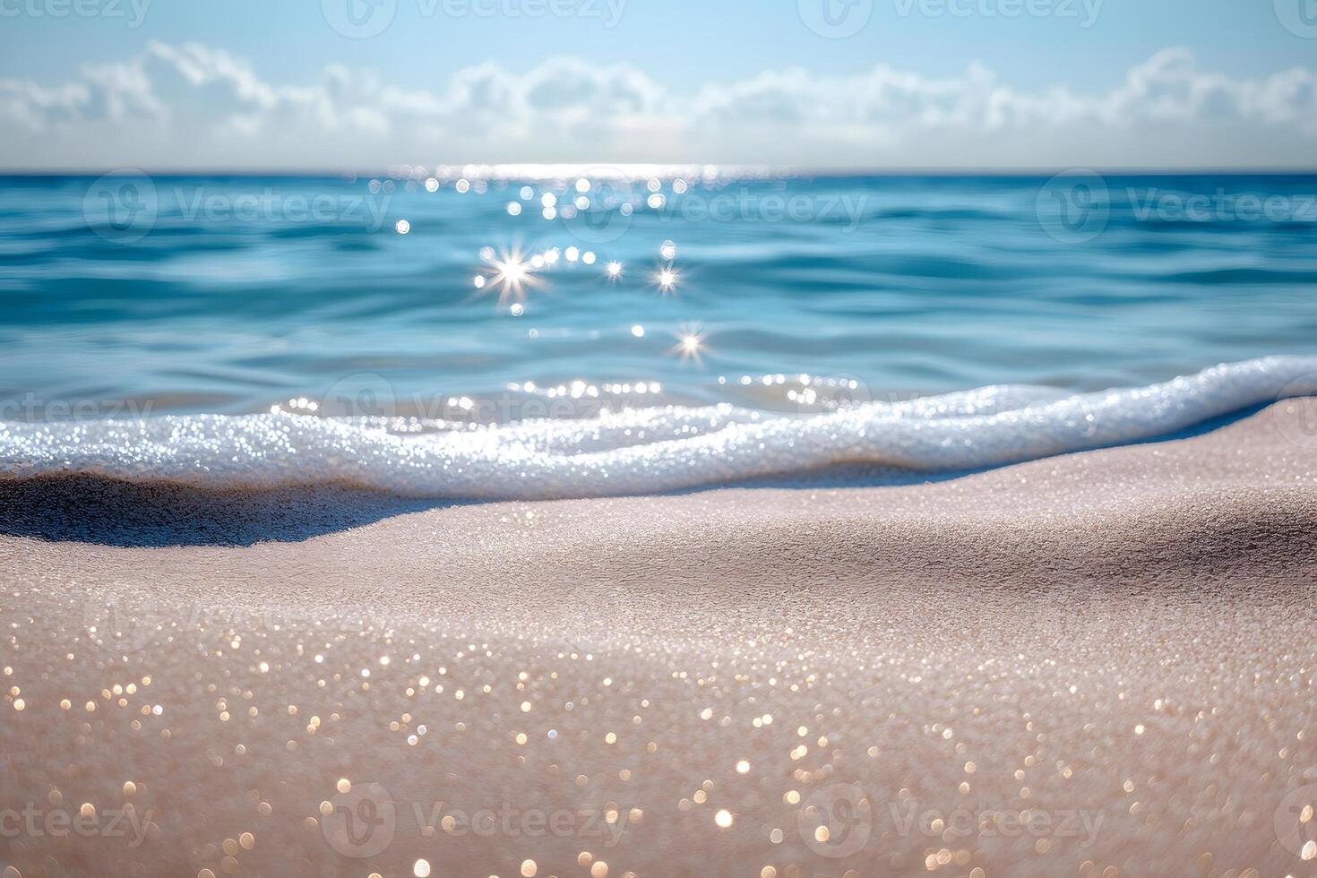 A sandy beach with waves and sun shining on it photo