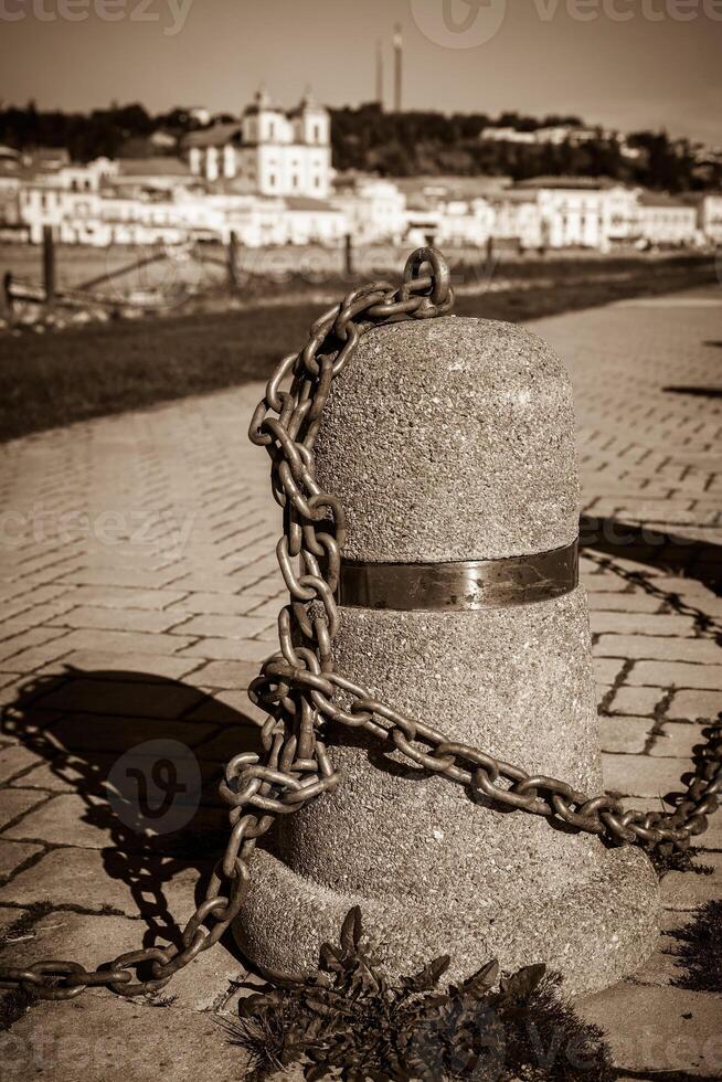 Stub posts linked in a chain on a quay photo