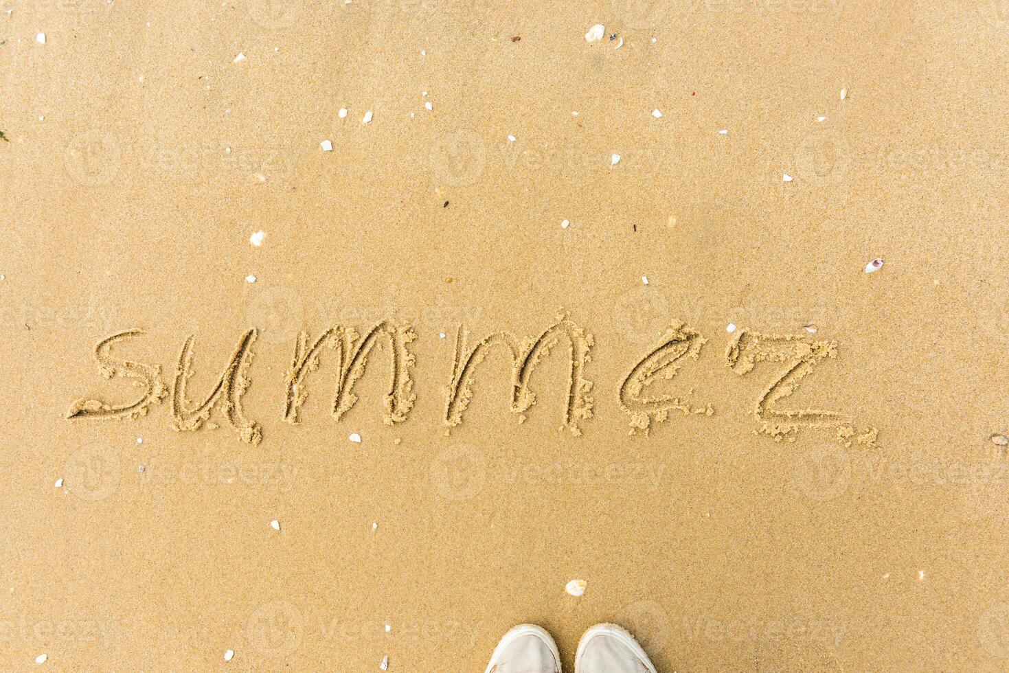 Summer written on the beach sand photo