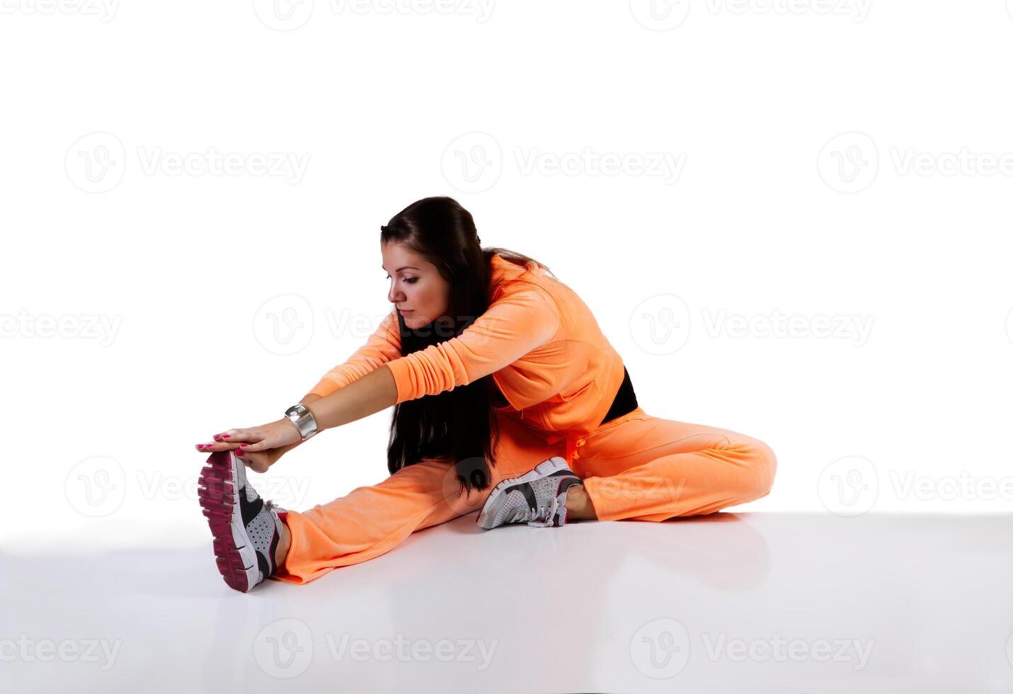 Young Caucasian Teen Woman Stretching In Orange Sweats photo