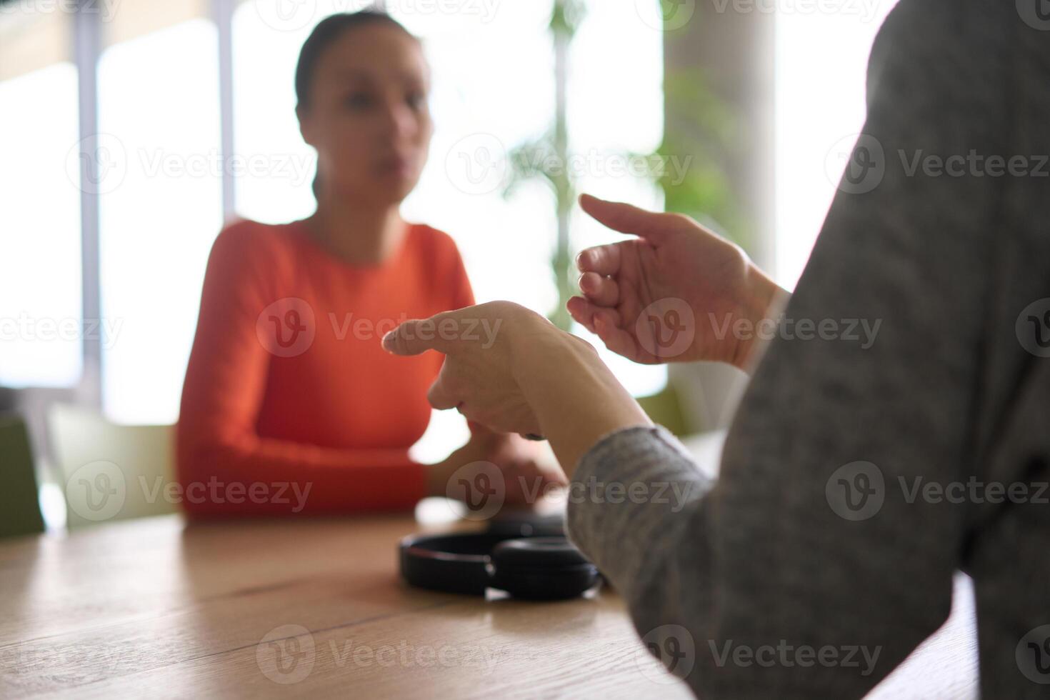 A young, diverse business team sitting together in a modern office, exchanging ideas and business plans, fostering collaboration and innovation for future success. photo