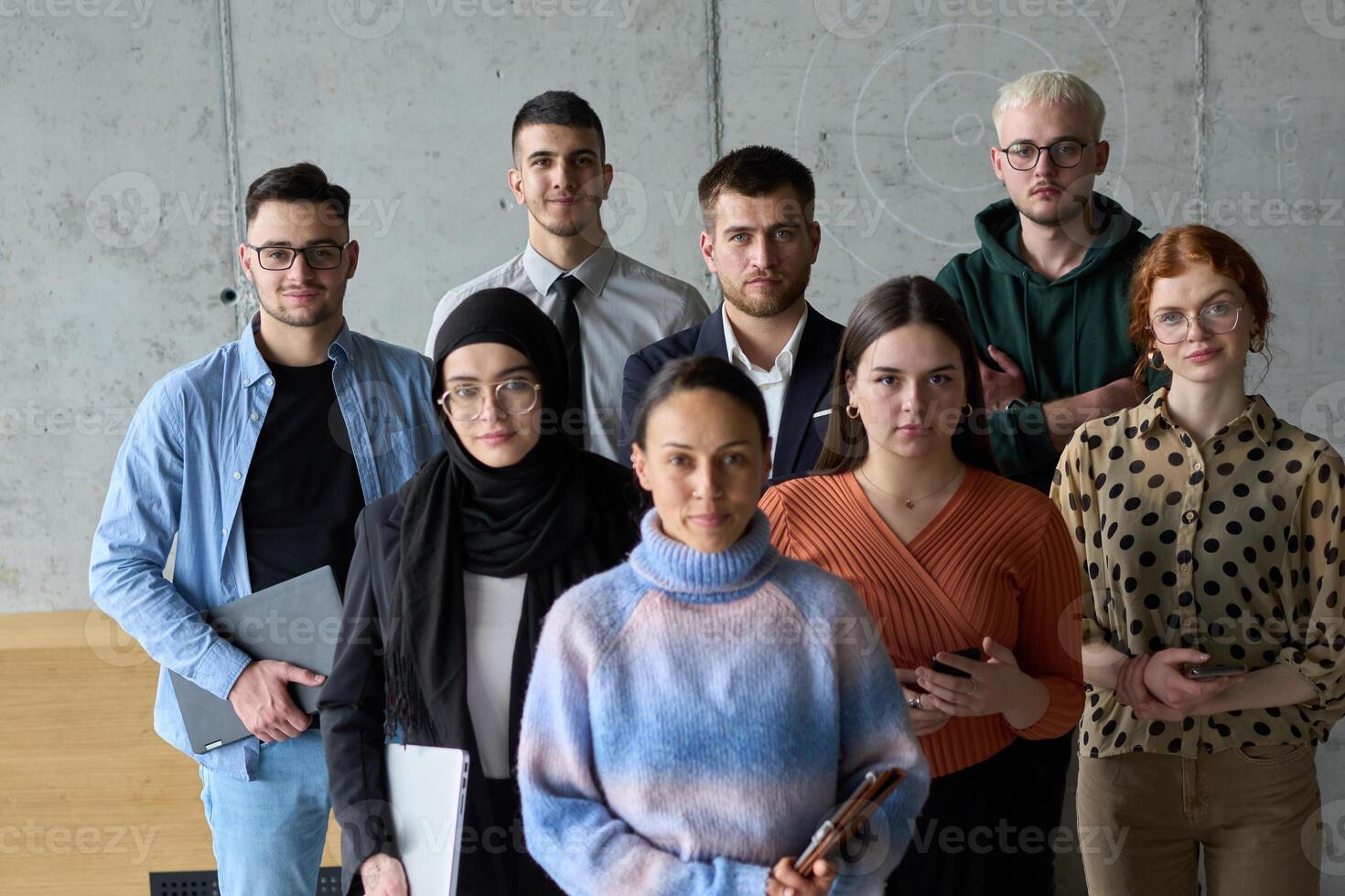 A diverse and determined team of business professionals stands confidently in an office, ready to tackle new business plans and challenges with a focus on success and growth photo