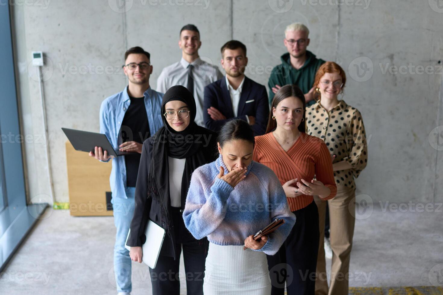 A diverse and determined team of business professionals stands confidently in an office, ready to tackle new business plans and challenges with a focus on success and growth photo