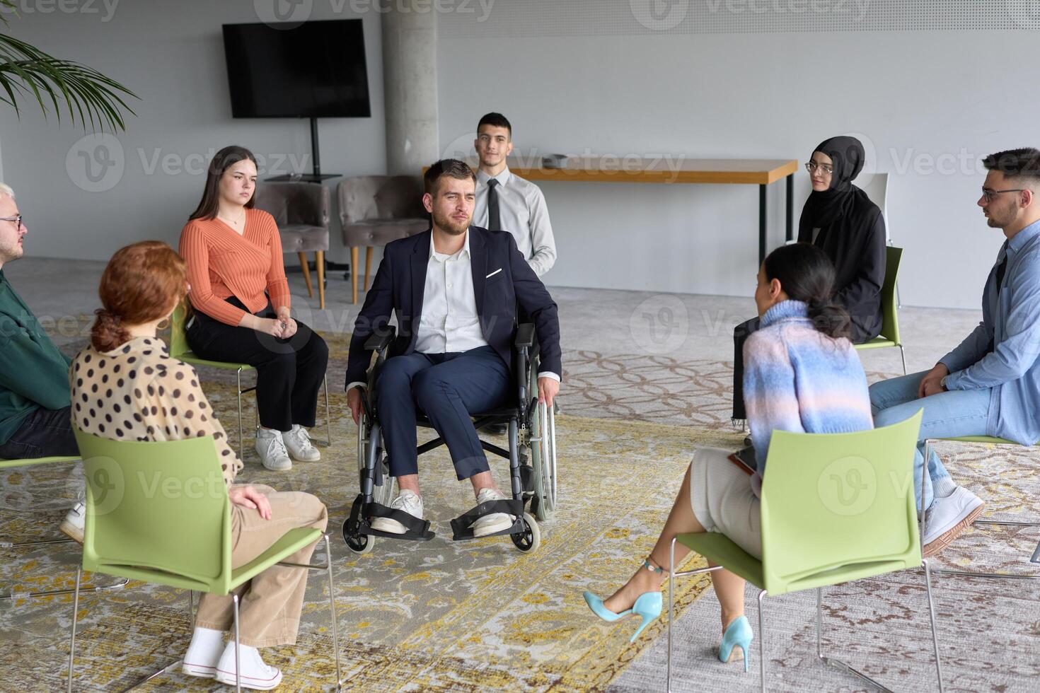 Corporate business team meeting with a manager or coach. Group of happy diverse, multiracial people sitting in a circle photo