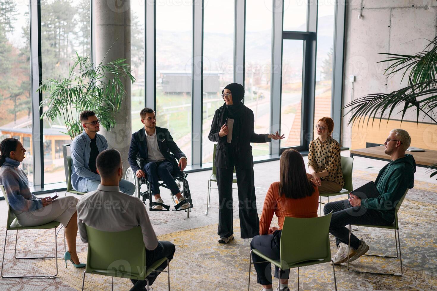 Corporate business team meeting with a manager or coach. Group of happy diverse, multiracial people sitting in a circle photo