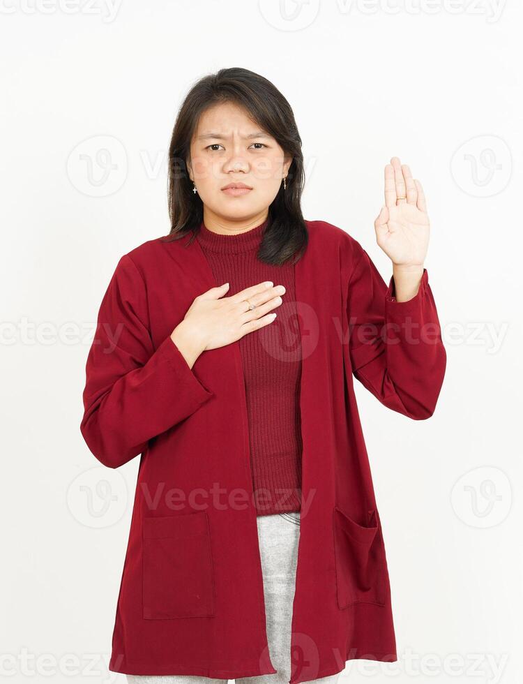 Swearing or Promise Gesture Of Beautiful Asian Woman Wearing Red Shirt Isolated On White Background photo