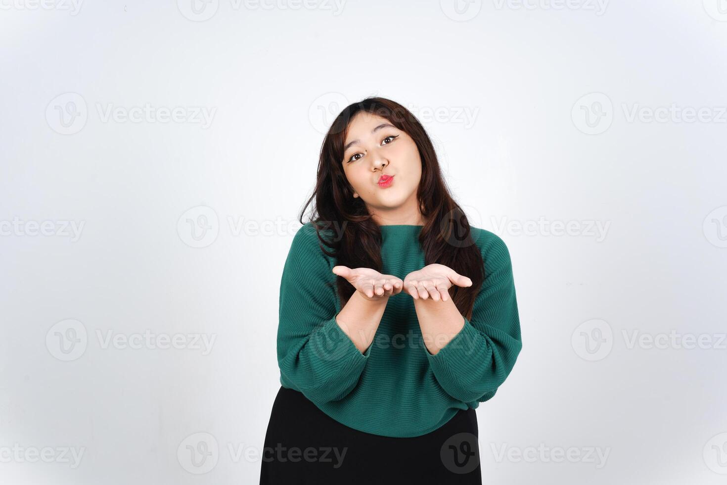 Blowing Kiss Of Beautiful Asian Woman wearing Green Isolated On White Background photo