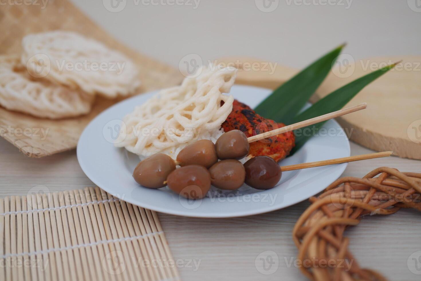 rice with skewered quail eggs and crackers on wood background. Selective focus. photo