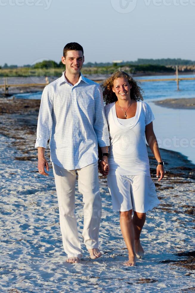 Young couple walking on beach photo
