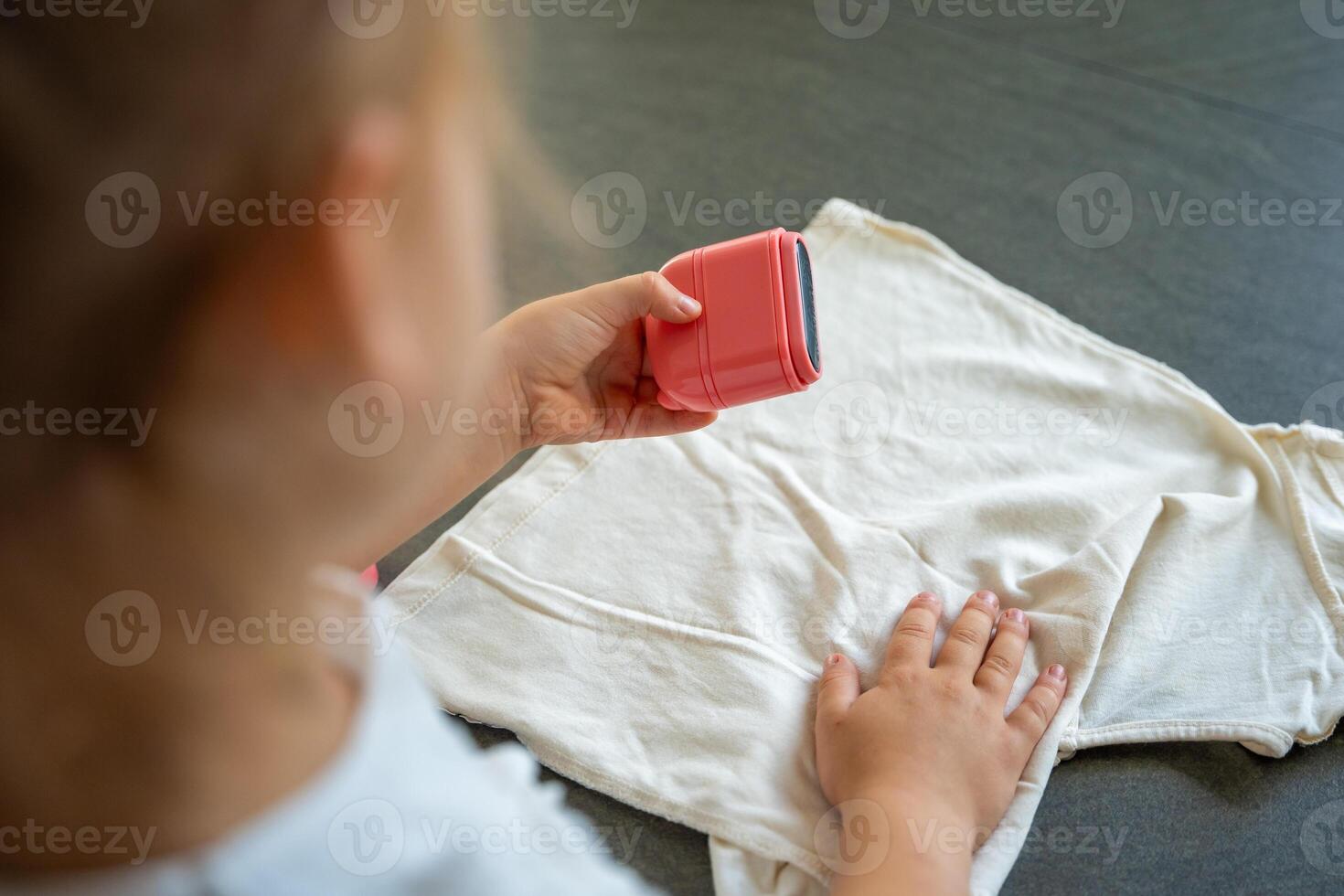 Back view of little girl with a stamp with a name for signing children's things. Identification of personal clothing. High quality photo