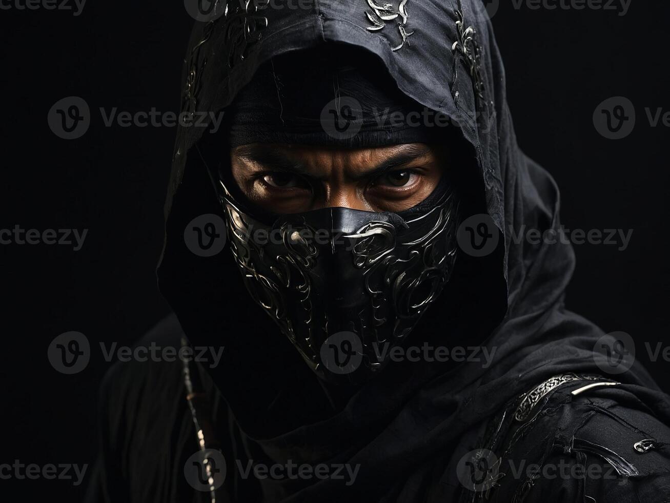Mysterious figure dressed in dark attire with a detailed mask against a black background photo