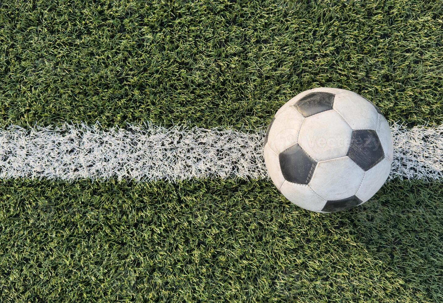 top view of football on green field, soccer ball on grass photo