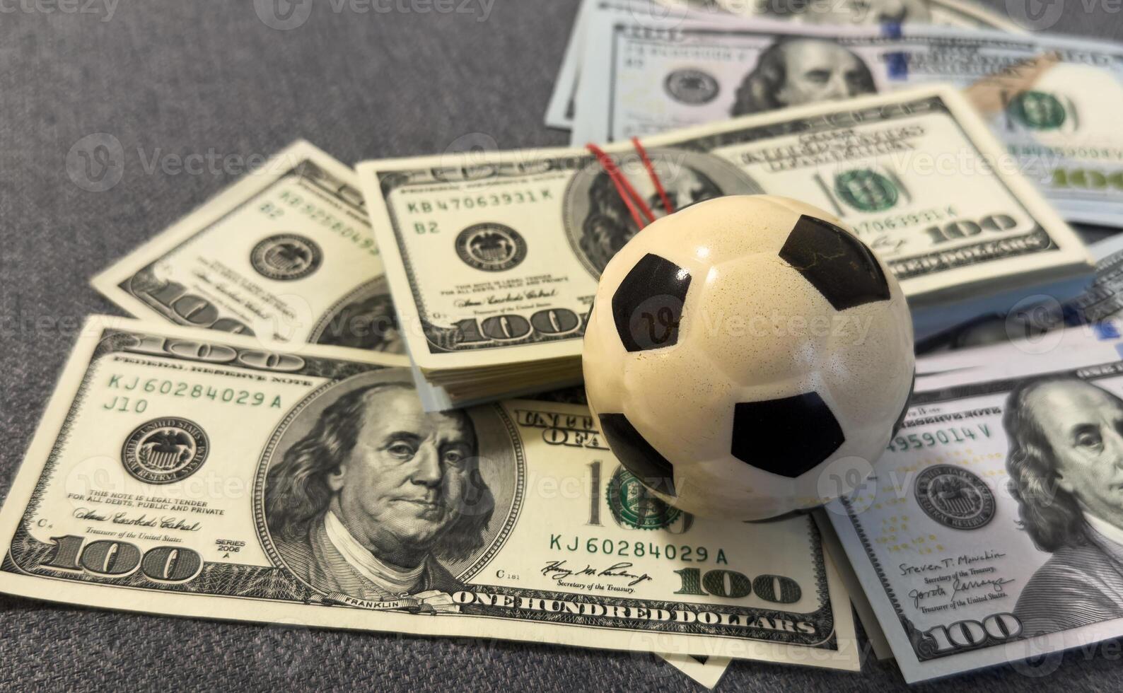 A soccer with big pile of banknote, white background, sport and business concept photo