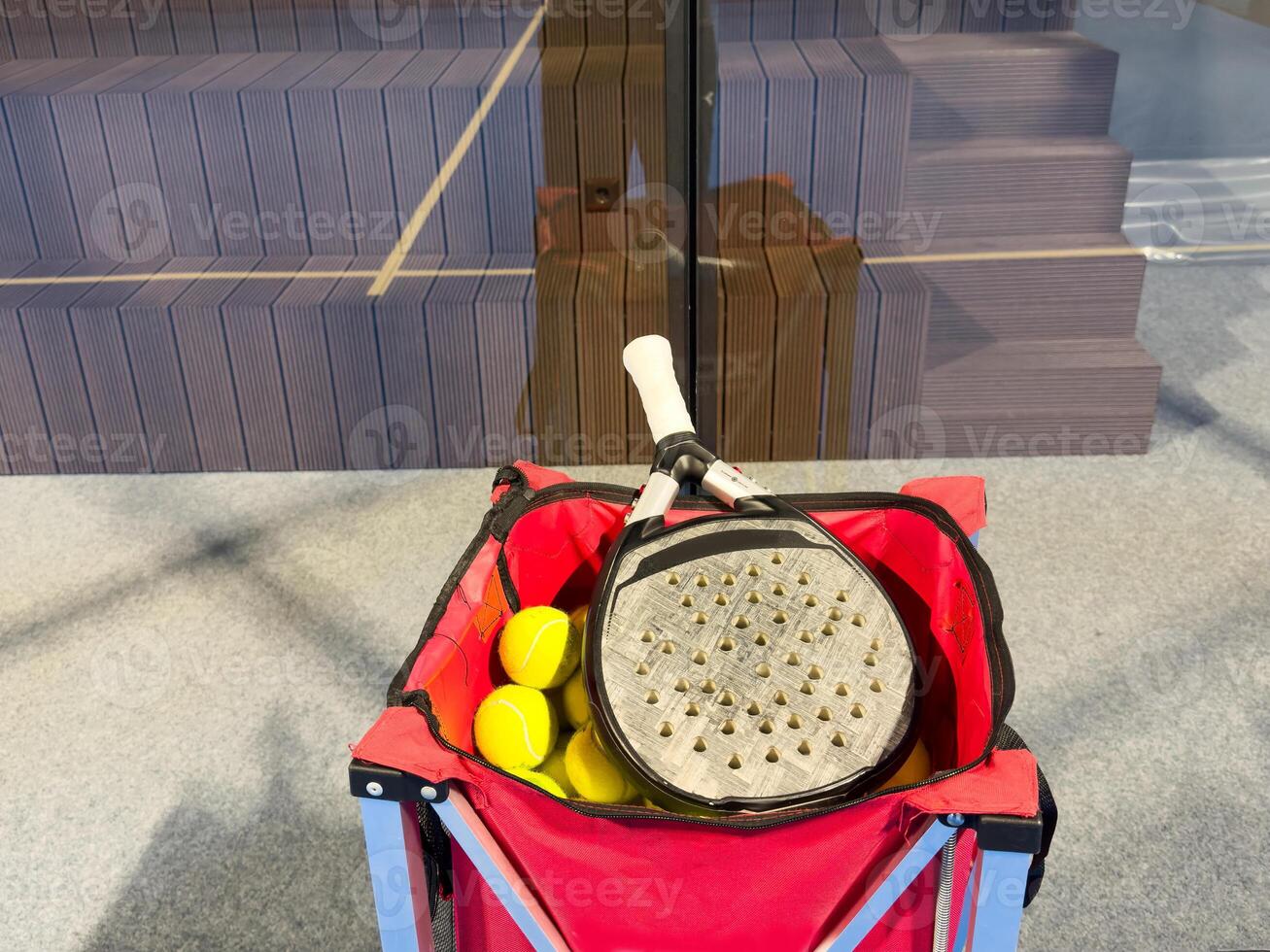 padel racket on a padel blue court with a ball photo
