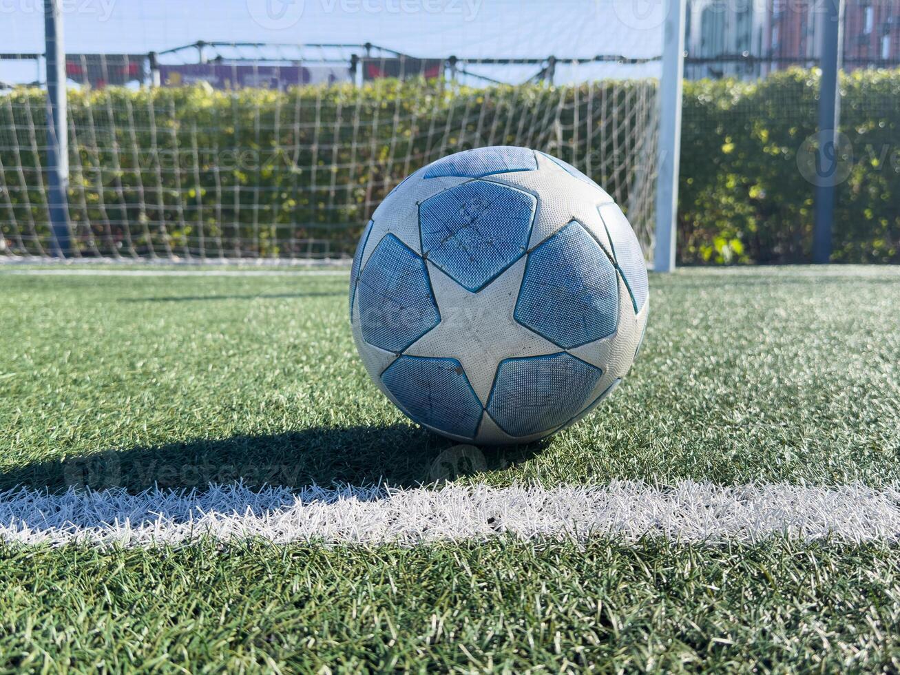 Soccer ball on a grass football field photo
