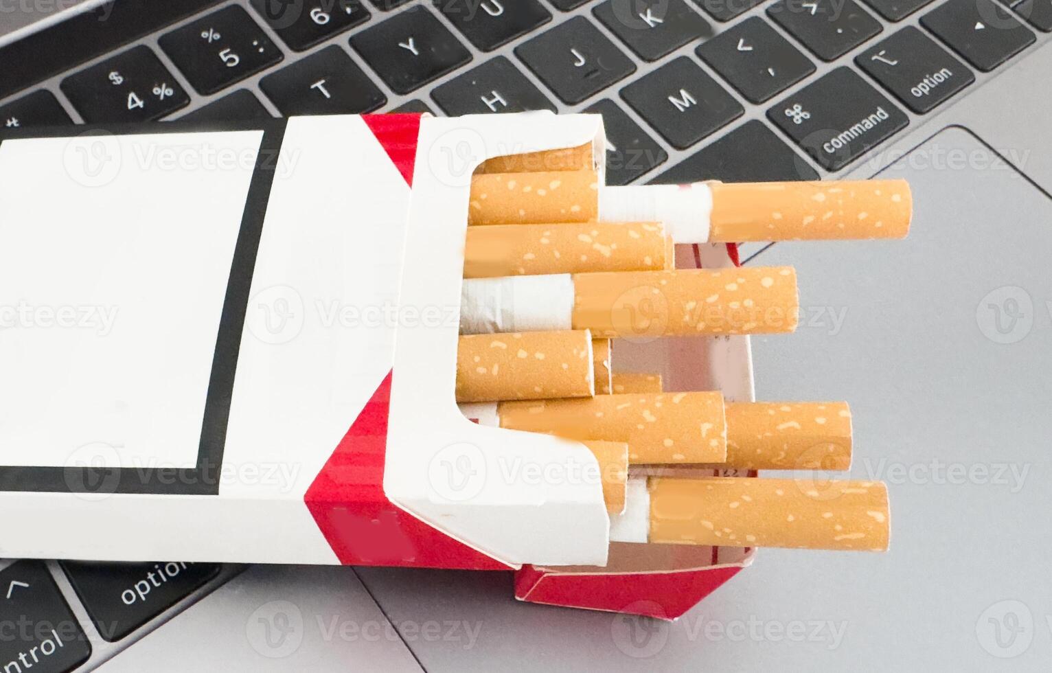 Close-up macro of cigarette on black keyboard photo