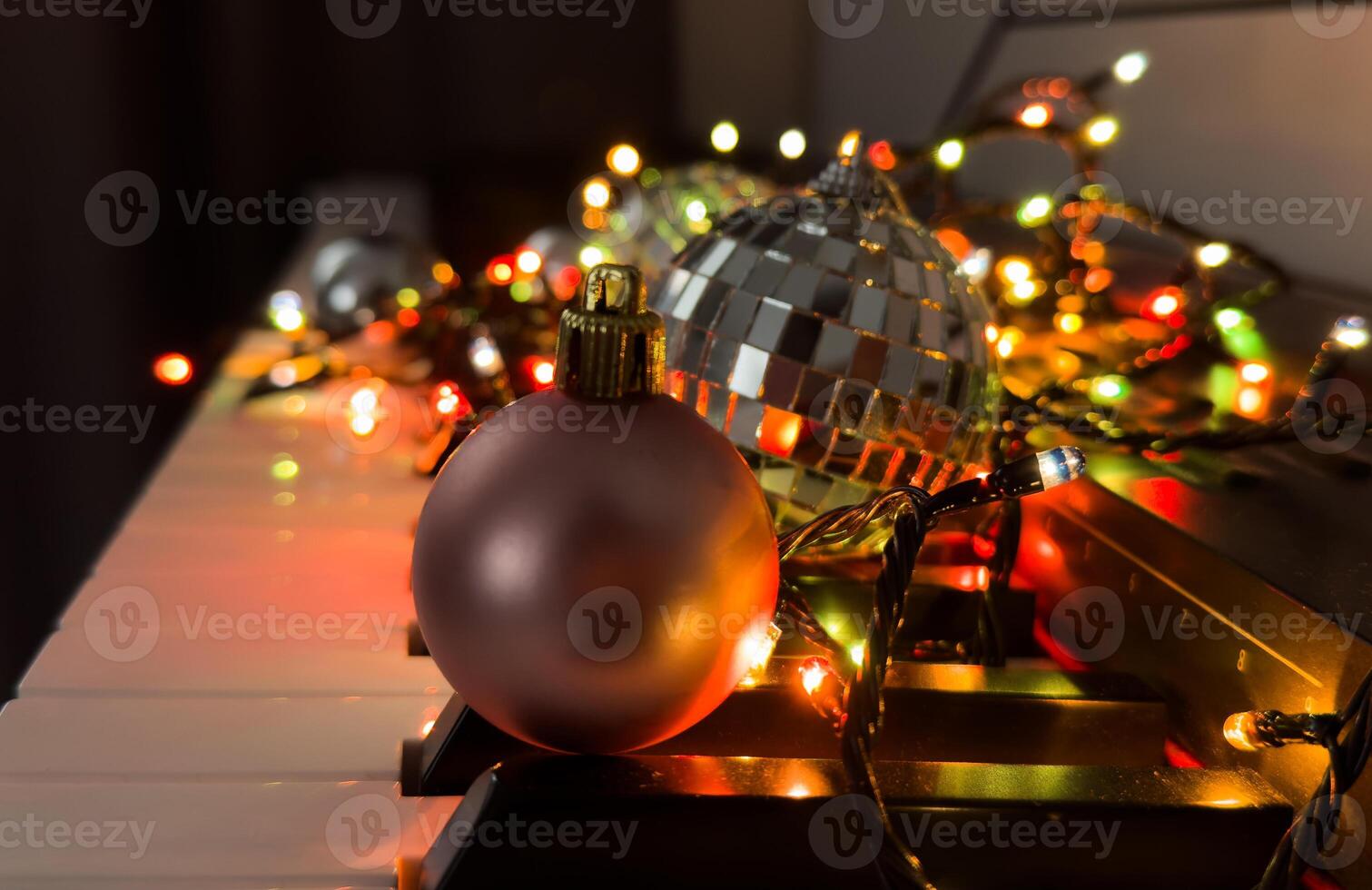 Piano keyboard with Christmas decoration, closeup photo