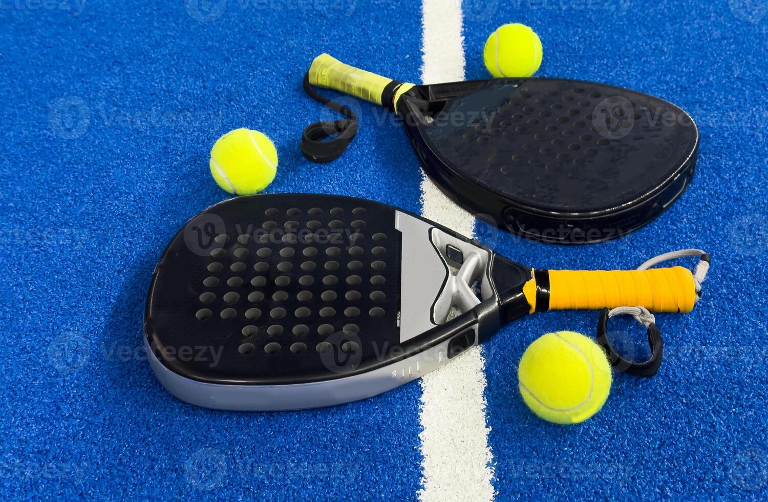 padel racket on a padel blue court with a ball photo