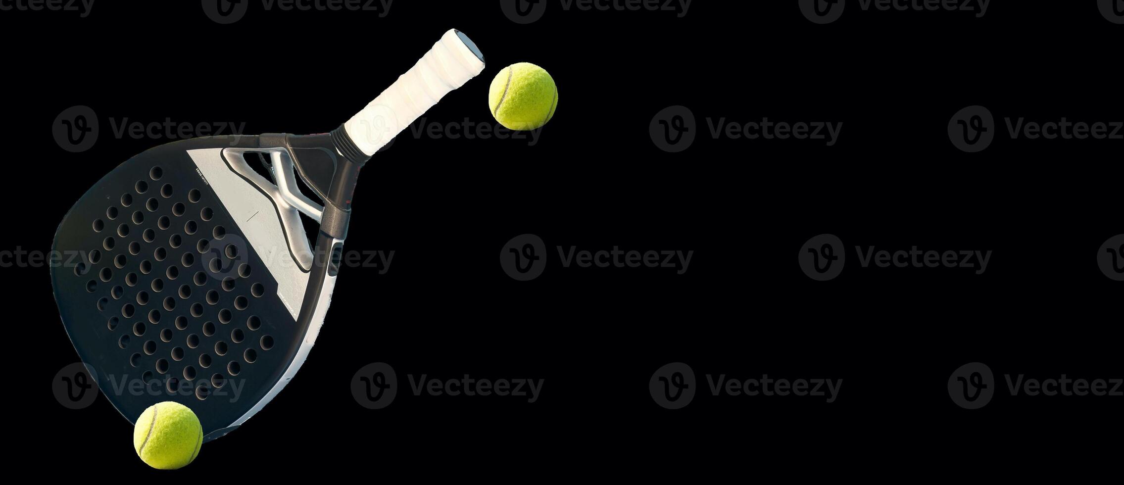 Background of black and white paddle tennis racket and two balls on a black table. Top view. photo