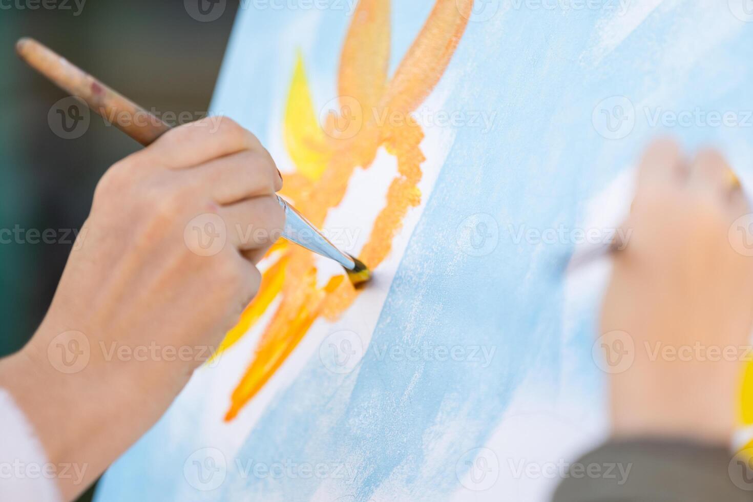 Child's hands drawing flowers on white sheet of paper. Top view. Children's and Earth day concept photo