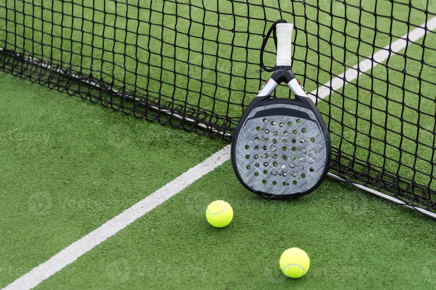 White professional paddle tennis racket with natural lighting on blue background. Horizontal sport theme poster, greeting cards, headers, website and app photo