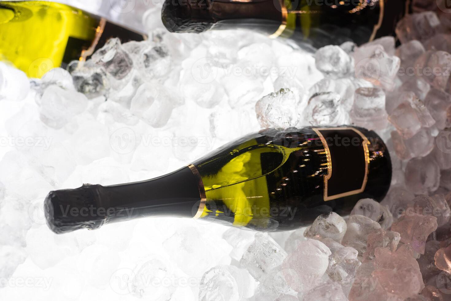 bottles of sparkling wine in ice photo