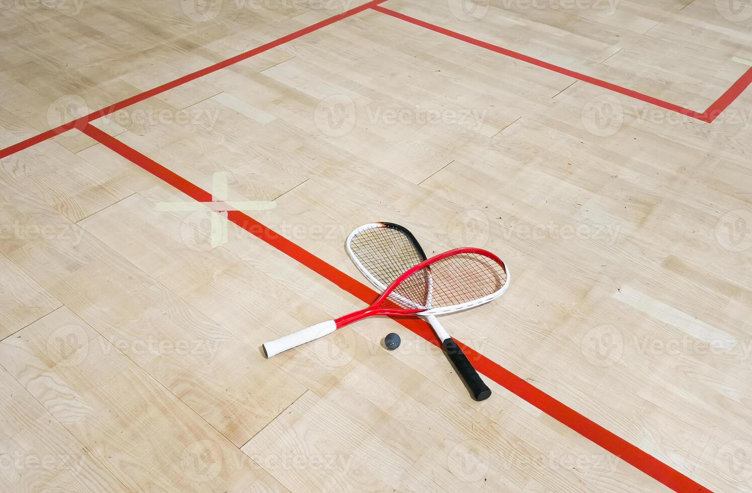 Empty squash court and rackets on the wooden floor. photo
