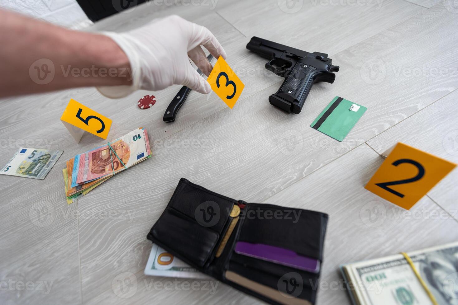 Close up on hands of unknown man forensic police investigator collecting evidence in the plastic bag at the crime scene investigation photo