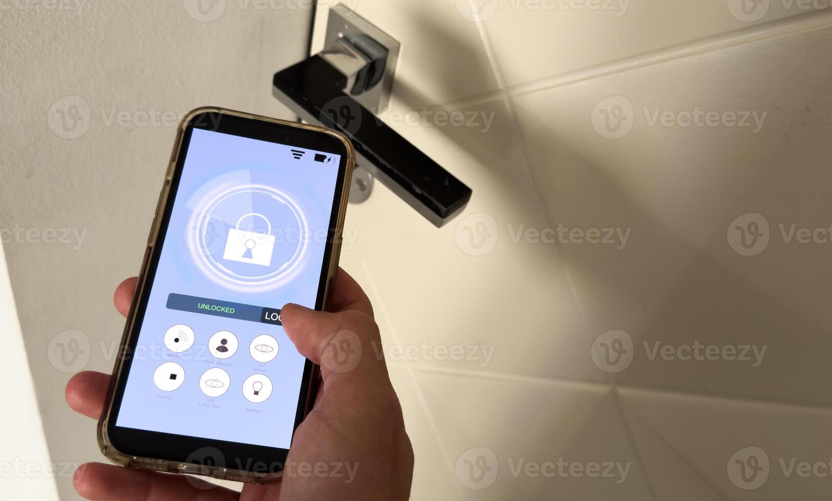 Smart house, home automation, device with App icons. Man uses his smartphone with smarthome app to control the lights of his house. photo