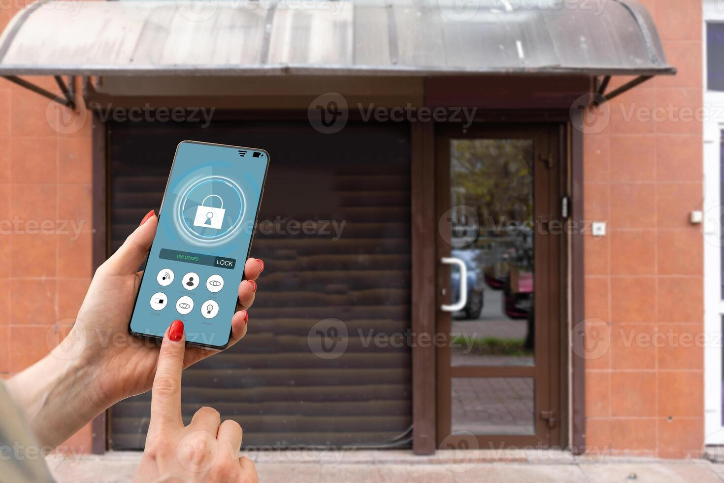 Cropped image of female entering secret key code for getting access and passing building using application on mobile phone, woman pressing buttons on control panel for disarming smart home system photo