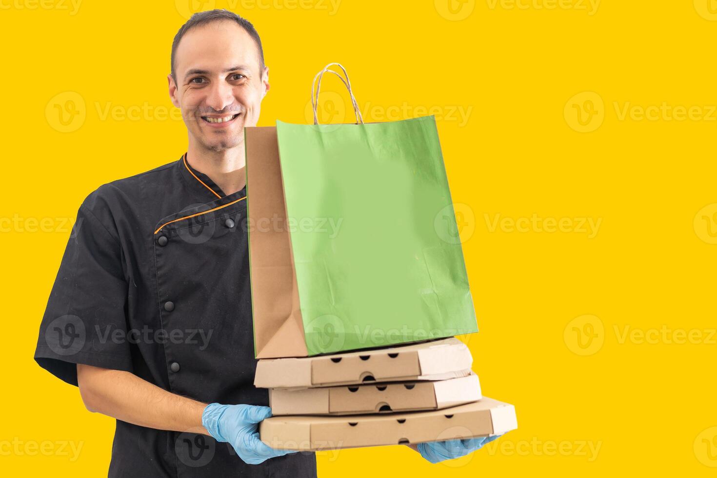 Diverse of paper containers for takeaway food. Delivery man is carrying pizza photo