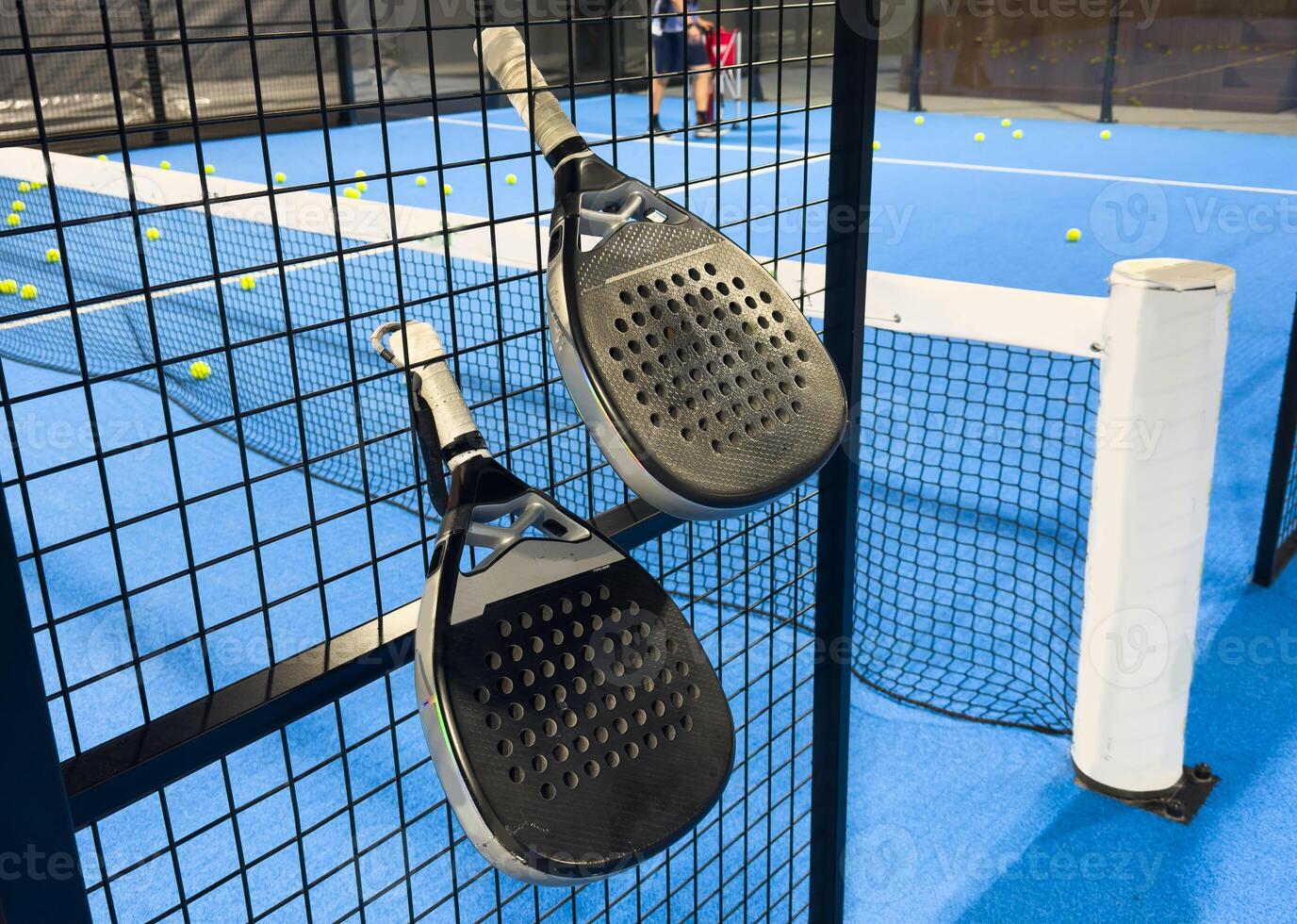 padel racket on a padel blue court with a ball photo