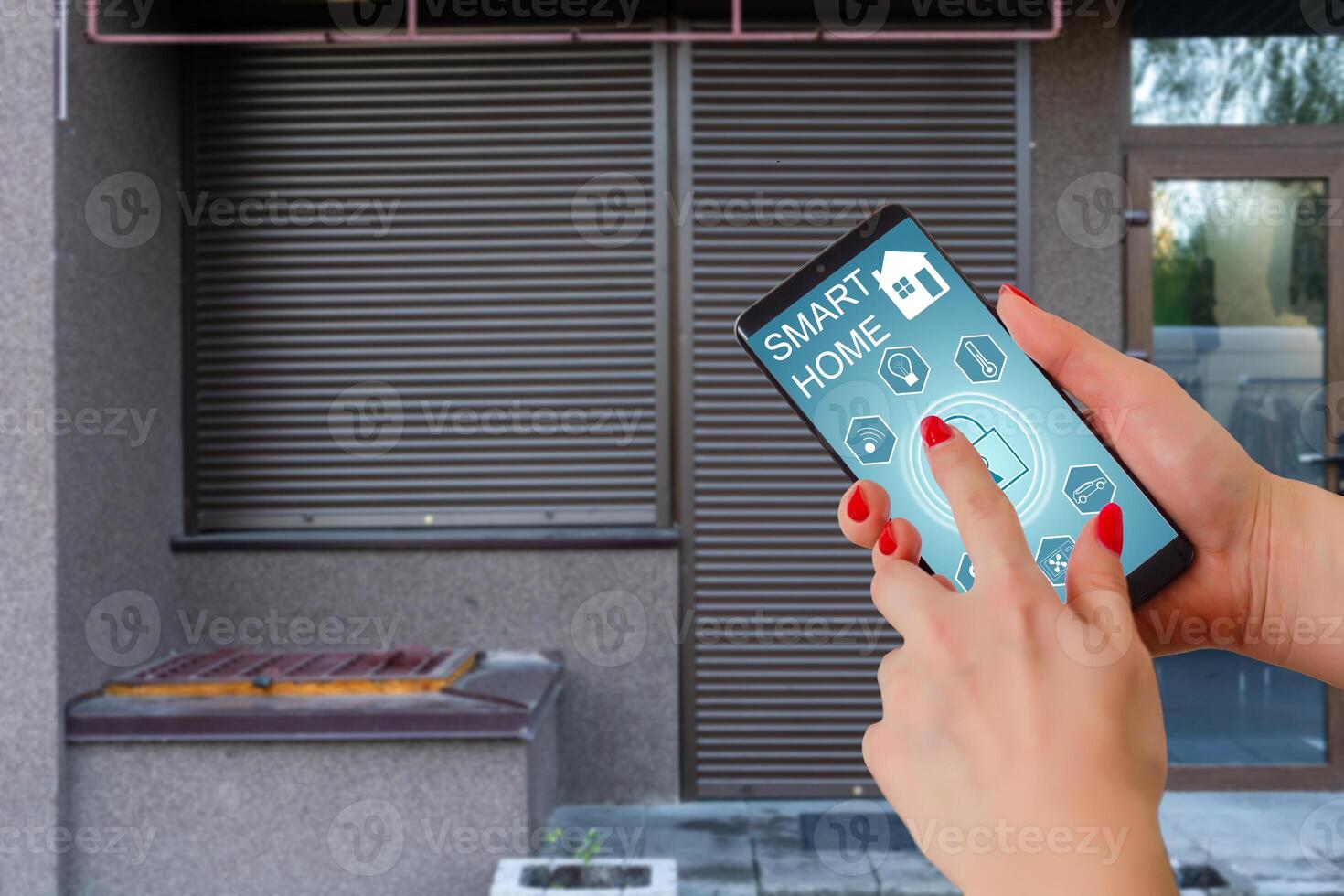 Cropped image of female entering secret key code for getting access and passing building using application on mobile phone, woman pressing buttons on control panel for disarming smart home system photo