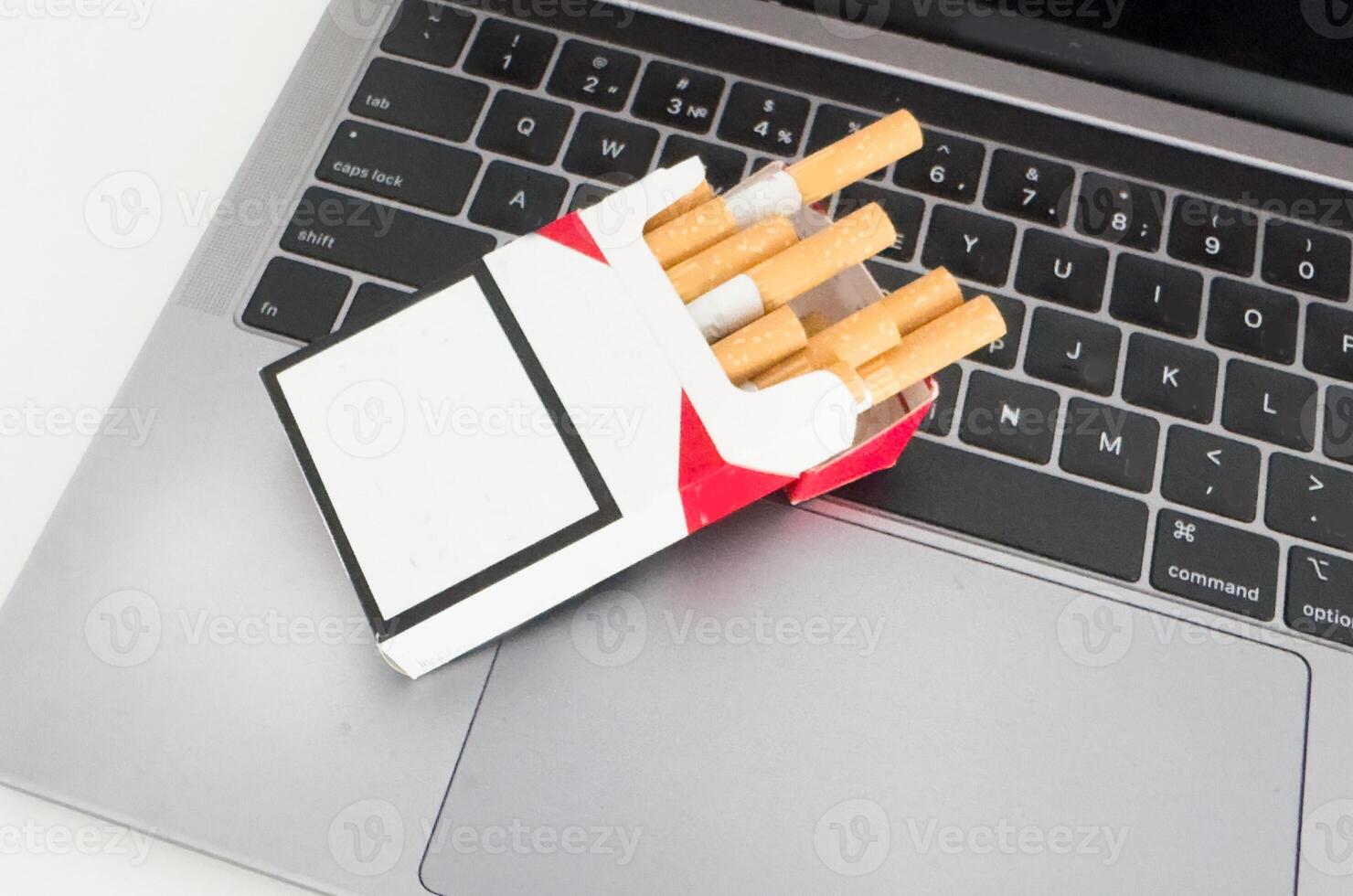 A cigarette and a laptop photo