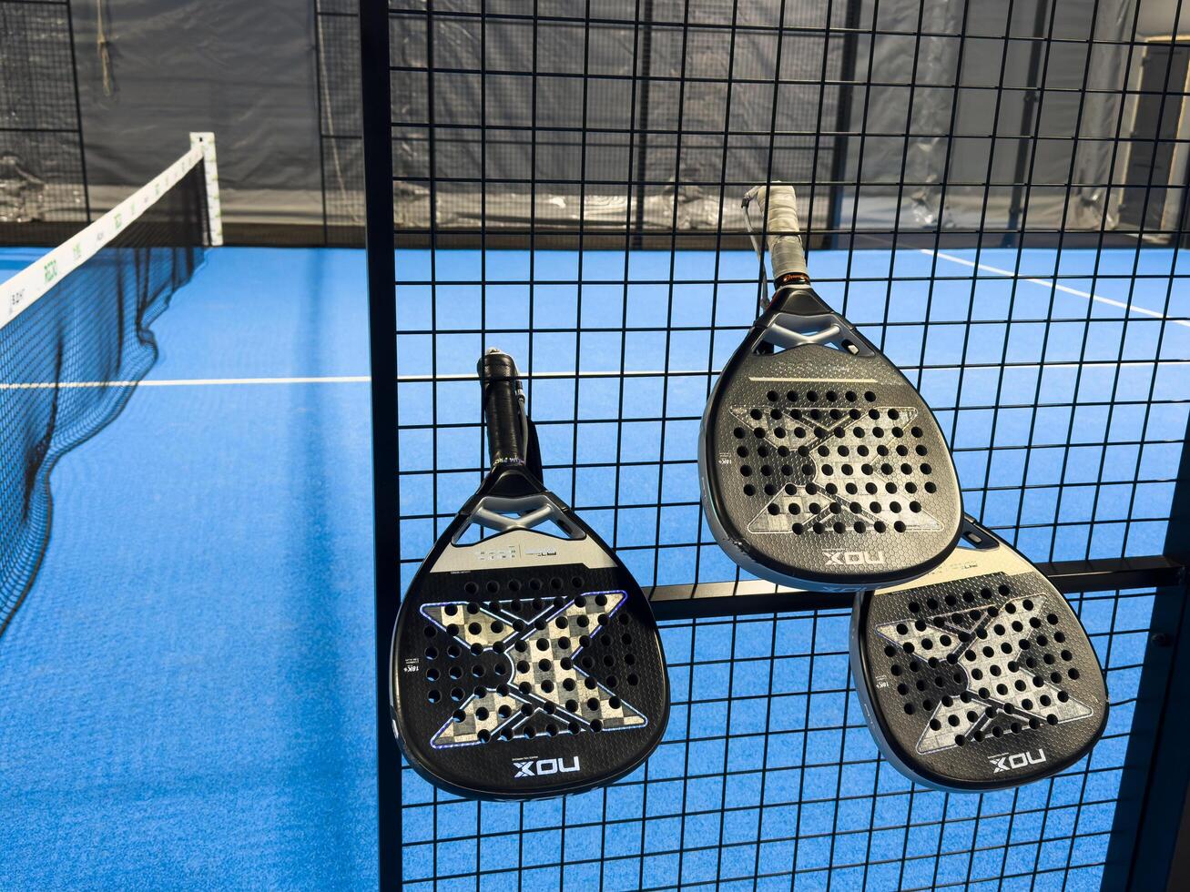 Kyiv, Ukraine, October 26, 2024. padel racket nox on a padel blue court with a ball photo