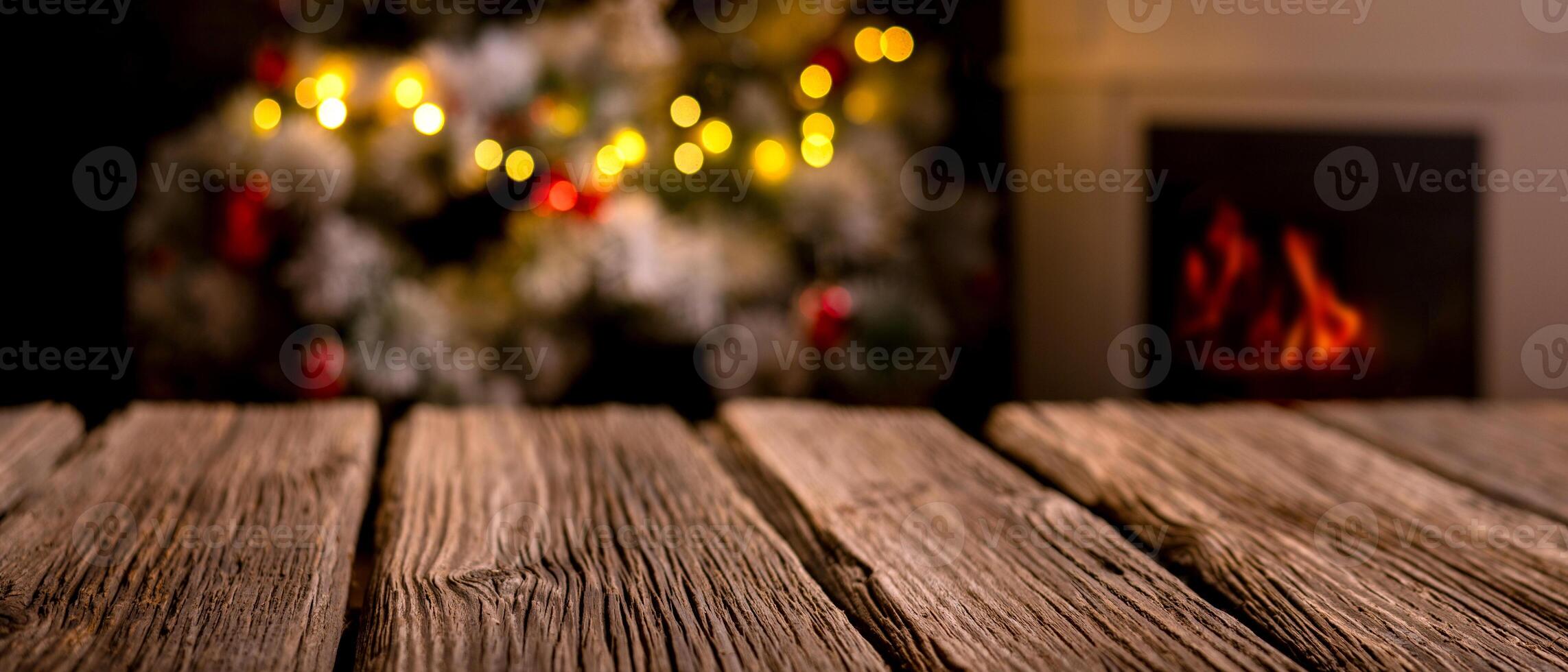 wooden table and blurred Christmas tree in background photo