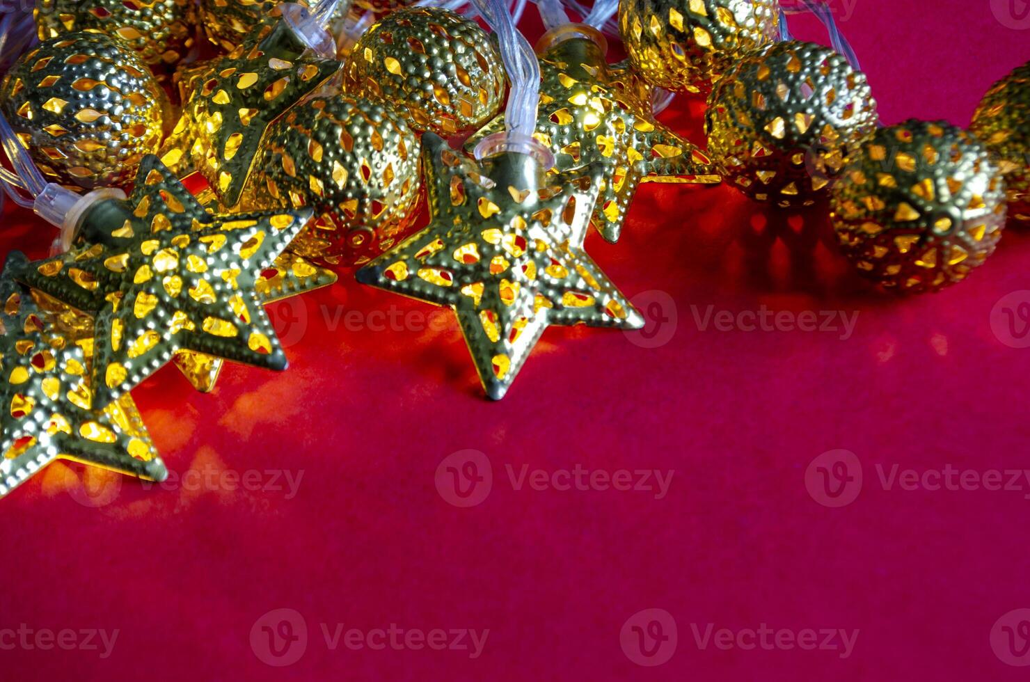 Close up of Golden Christmas balls and stars with customizable space for text. Holiday season photo