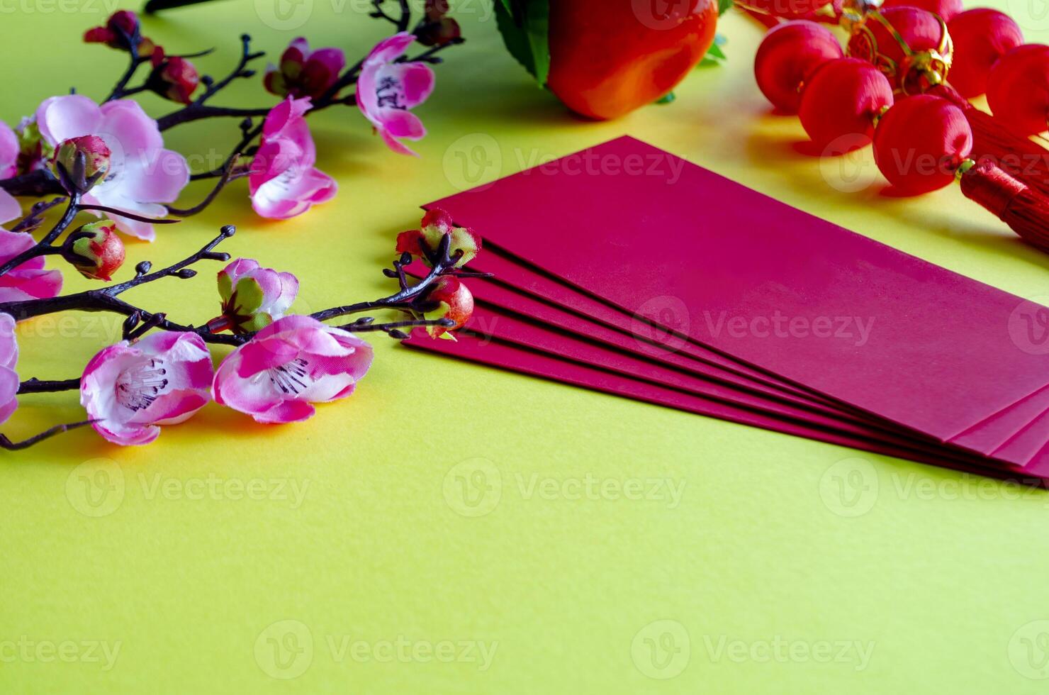 Chinese New Year decoration with red packets on yellow cover background with customizable space for text. Chinese New Year celebration concept photo
