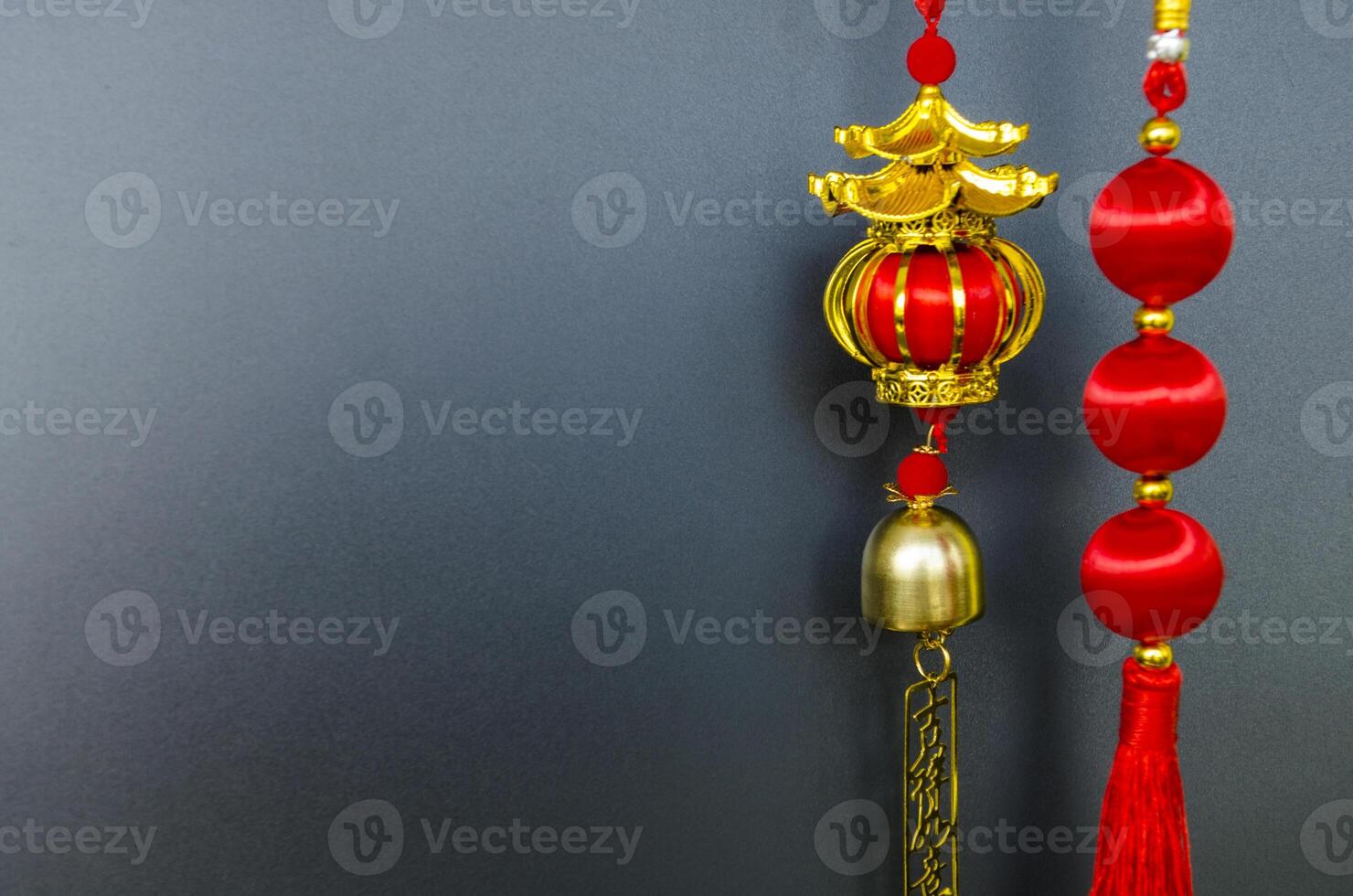 Chinese New Year lantern with hanging golden message meaning safe journey. Black cover background with customizable space for text photo
