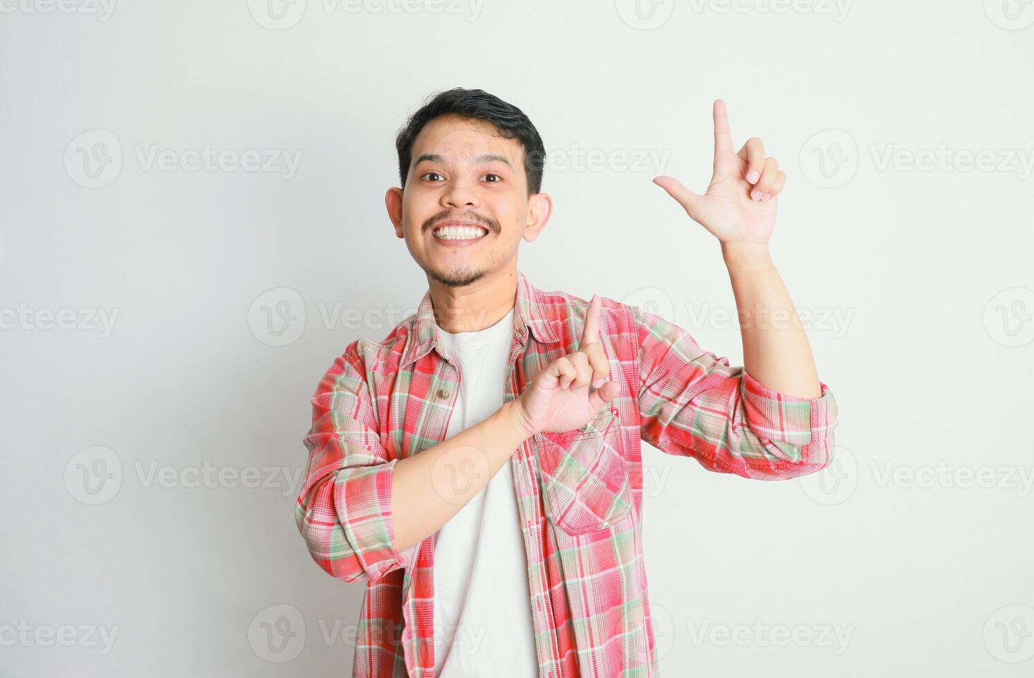 an asian man smiles and points to something with his hand, advertising concepts photo