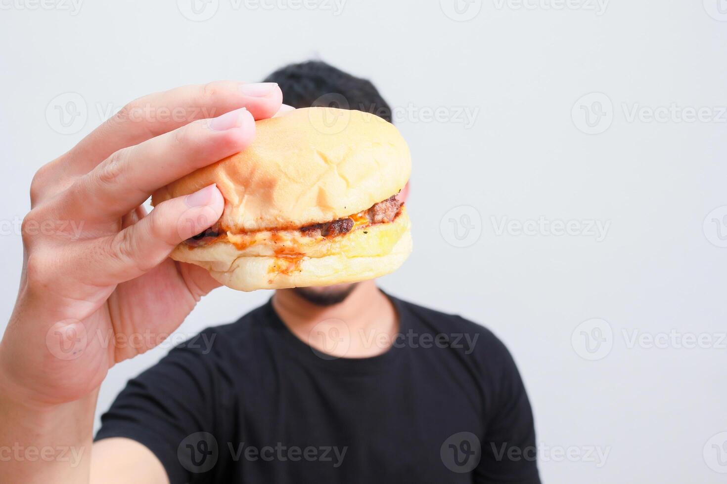 a close up image of an asian man holding hamburger isolated on white background photo