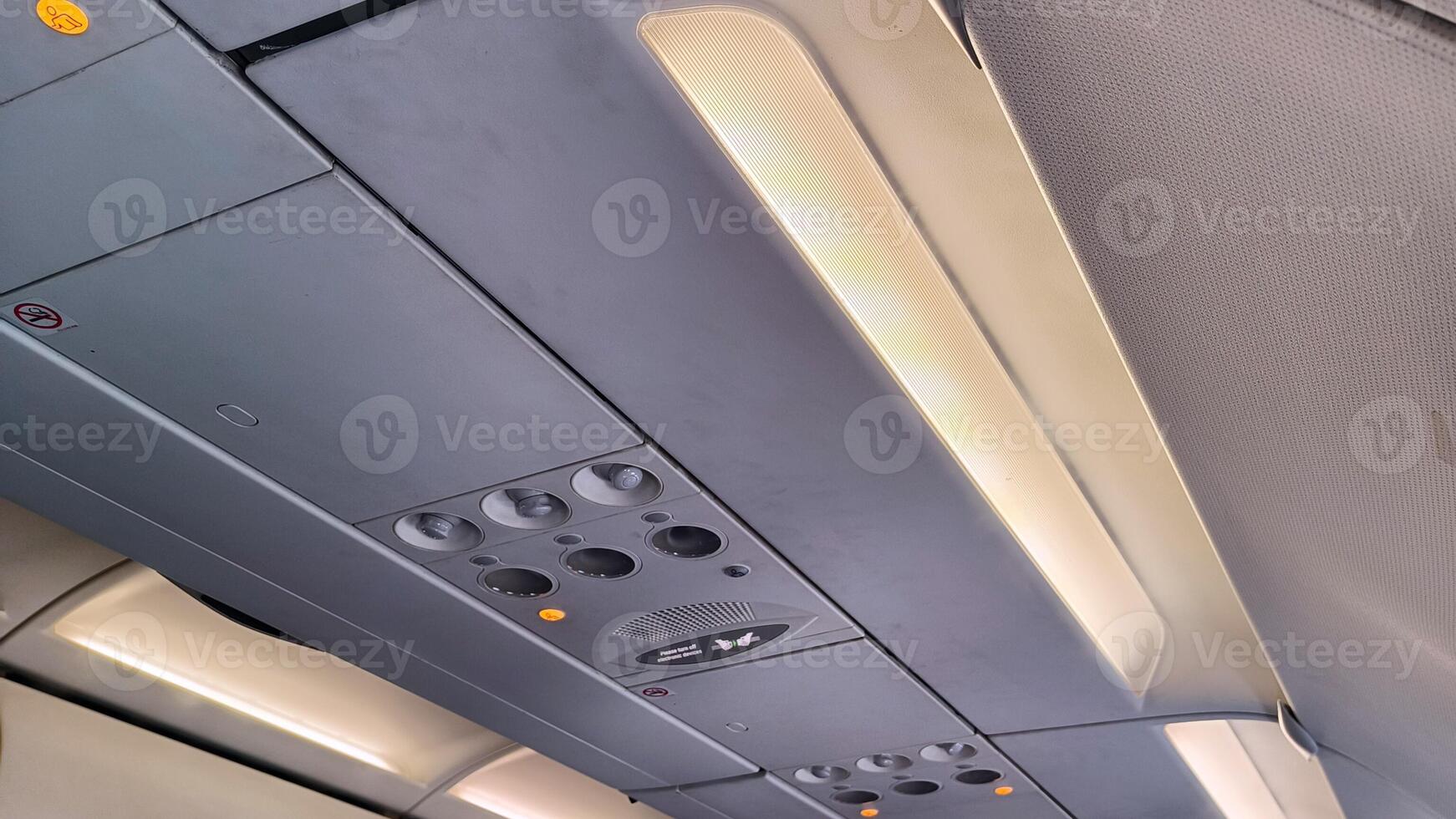Airplane air conditioning interior above the passenger seats photo