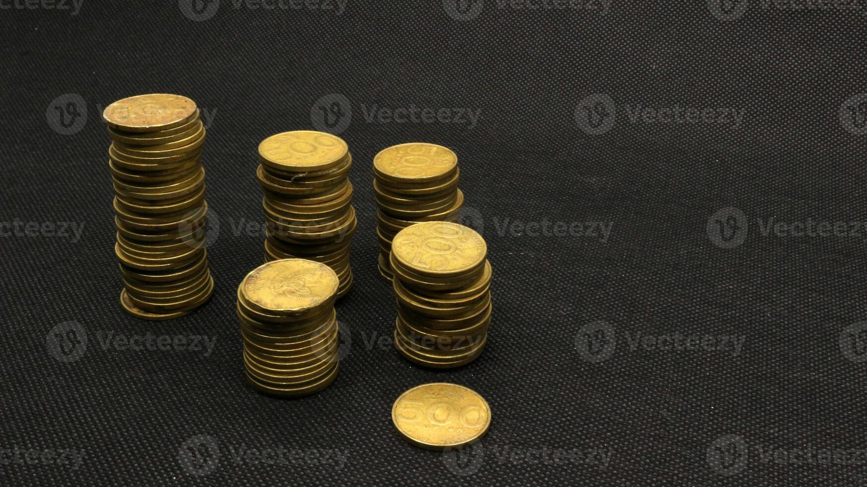 Stack of five hundred rupiah yellow Indonesian coins photo