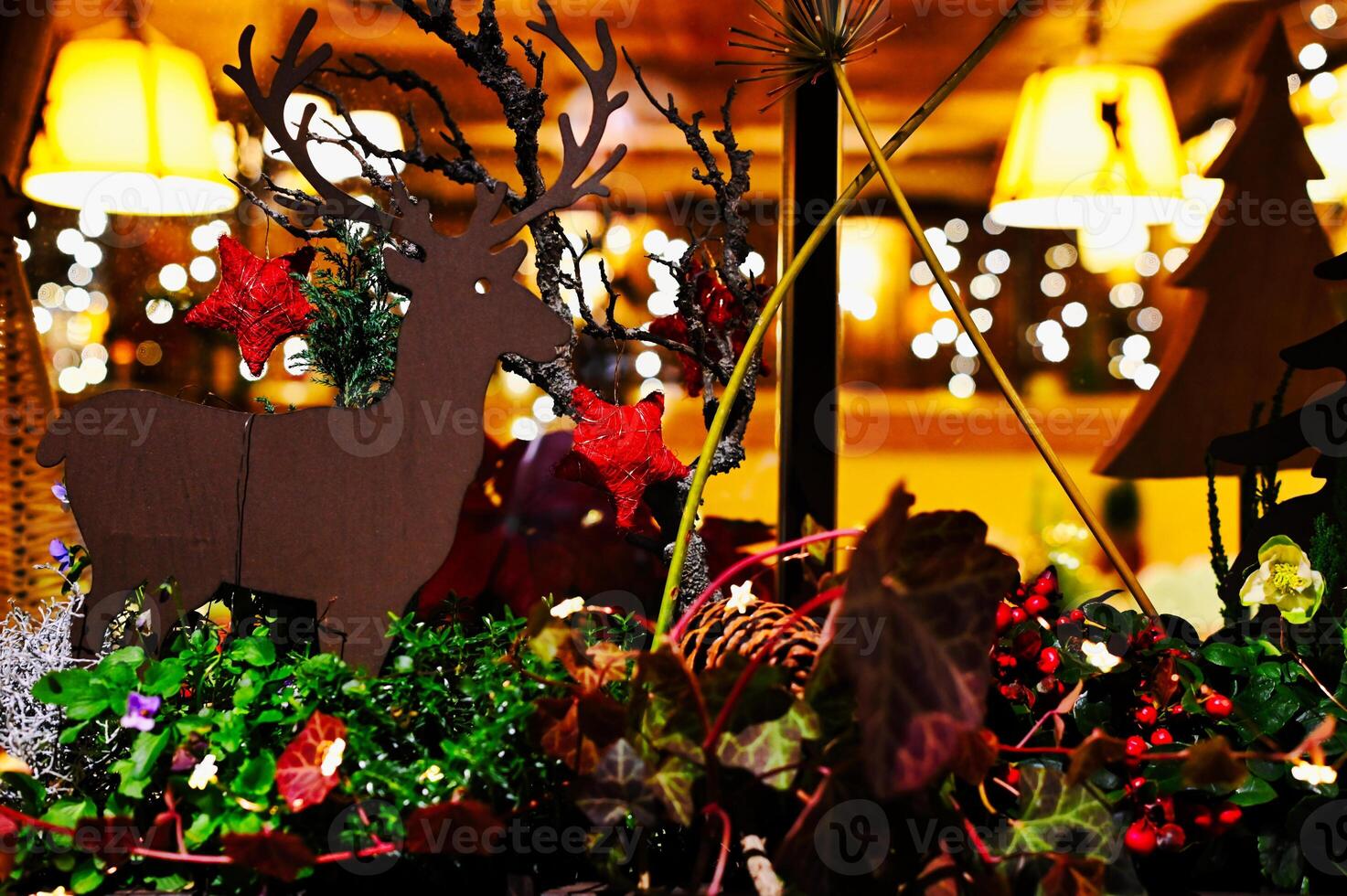 christmas decorations in a window at night photo