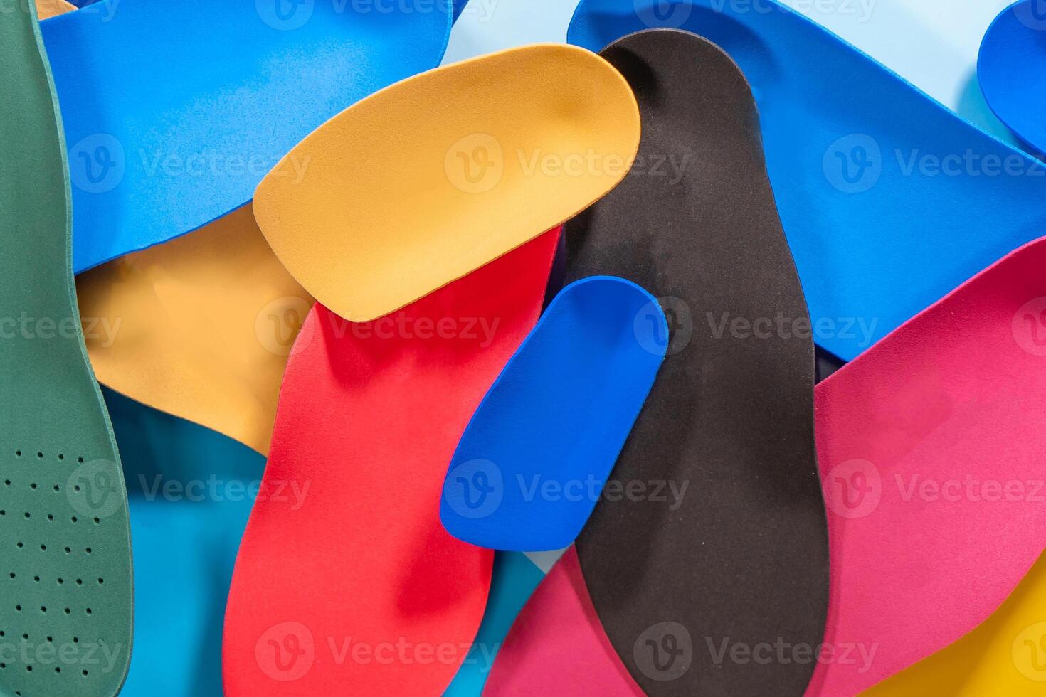 Foot support and healthy feet concept with orthopedic shoe insoles isolated on color background photo